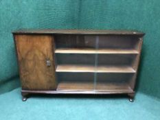 A walnut sliding door bookcase
