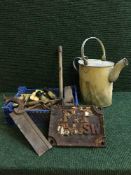 A basket of assorted hand tools, vintage tins, field glasses, cast iron plate F.P.
