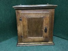 An antique oak hanging corner cabinet