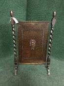 An Arts and Crafts oak and copper fire screen