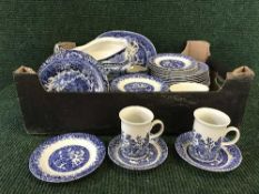 A box of blue and white Willow pattern dinner ware,