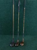 Three hickory shafted golf clubs