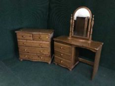 A pine serpentine fronted five drawer chest with matching dressing chest with mirror