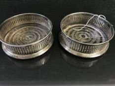 Two silver wine coasters