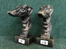 Two cast metal Greyhound heads on stands (2)