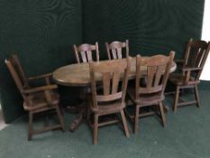 A heavy oak dining table together with six chairs