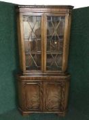 A mahogany glazed door corner cabinet