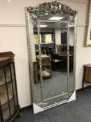 An ornate silvered sectional mirror