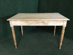 An antique pine kitchen table fitted with a drawer