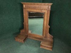 An antique mahogany dressing table mirror