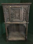 A heavily carved oak buffet cabinet on stand
