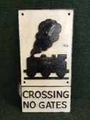 A cast metal plaque - Train level crossing