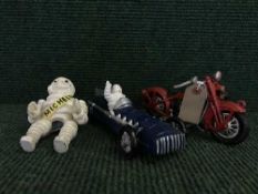 A cast metal figure - Michelin man on bike together with a Michelin racing car