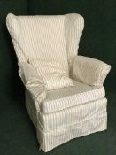 A mid 20th century wing back armchair