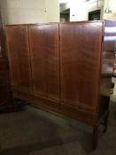 A mid 20th century teak triple door sideboard