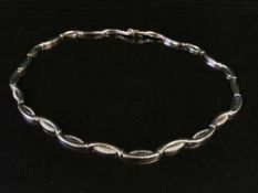 A 9ct white gold stone set necklace, 22.