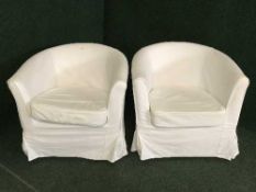 A pair of contemporary tub chairs with white loose covers