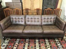 A late 20th century brown leather three seater settee