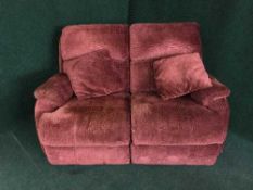 A two seater electric reclining settee in red covering