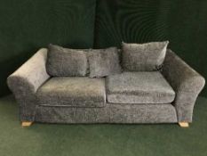 A contemporary two seater settee in grey covering