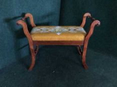 A mahogany piano stool