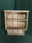 A rustic pine wall shelf