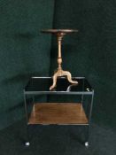 A mid twentieth century teak and chrome glass topped serving trolley together with a wine table