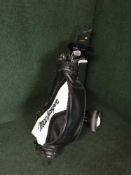 A McGregor golf bag and set of McGregor clubs on trolley