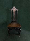 An antique oak valet chair by Papworth Industries,