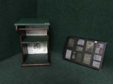 A painted stand with towel rail and a set of printers plates mounted on an oak board