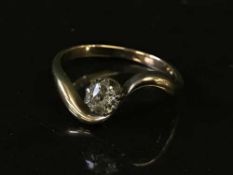 A diamond solitaire ring on yellow metal shank