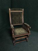 An Edwardian oak rocking chair