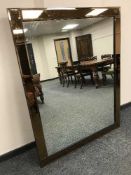 A two-tone contemporary glass mirror