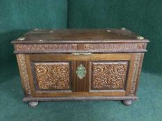 A carved mahogany blanket chest with brass fittings