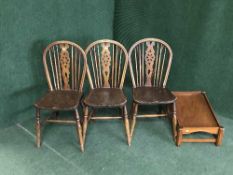 Three oak wheel back chairs and a stool