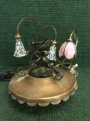 A metal and copper light fitting and two Tiffany style lamps
