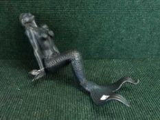 A cast metal figure - seated mermaid