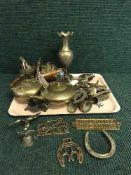 A tray of assorted brass ornaments, horse brasses,