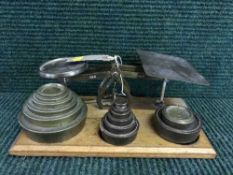 A set of early 20th century postal scales and weights