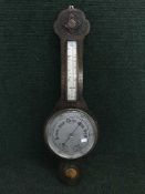 An early 20th century carved oak banjo barometer
