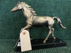 A cast metal horse figure on marble base