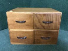 An oak four drawer index chest