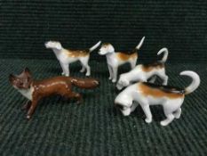 A Beswick figure - fox together with four fox hounds.