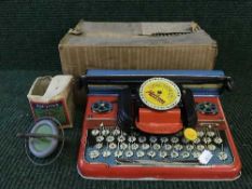 A boxed tin plate Mettypa Junior typewriter and a boxed Top Toys gyroscope top
