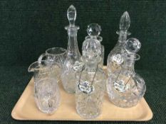 A tray of lead crystal decanters with labels,