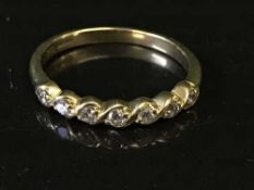 An 18ct gold diamond set half-eternity ring