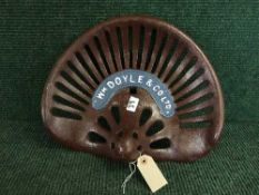 A cast metal W M Doyle tractor seat