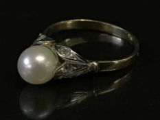A pearl ring on gold shank
