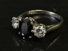 An 18ct white gold diamond and sapphire three stone ring