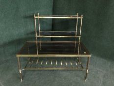 A brass and glass coffee table and a three tier stand